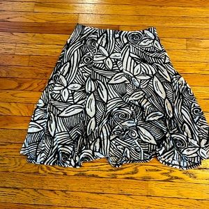 Chicos, Travelers size 2, black and cream color skirt length is past the knee.
